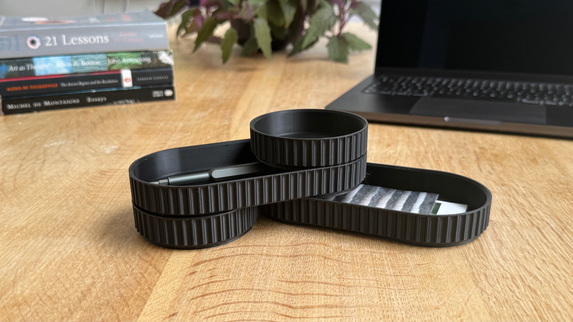 Stacked and arranged modular desk organiser pieces on a wooden desk