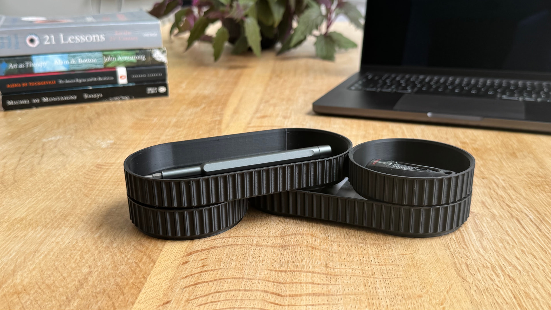 Connected modular desk organiser trays holding a pen and USB drive
